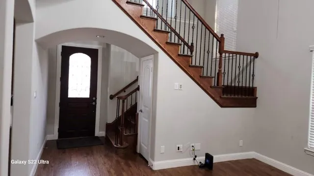 a view of entryway with wooden floor and stairs