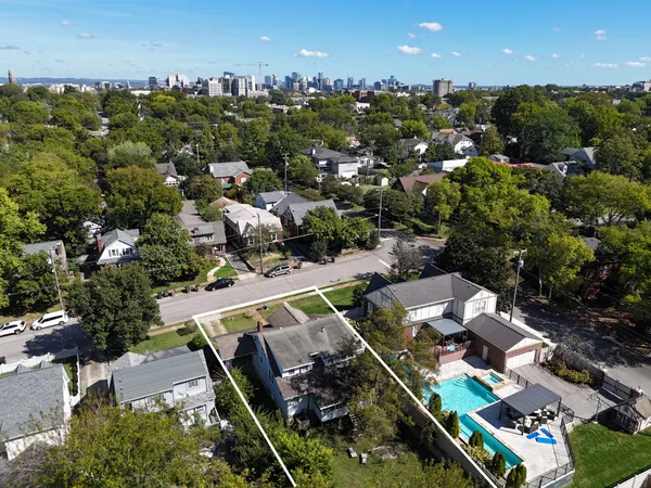 an aerial view of multiple houses with yard