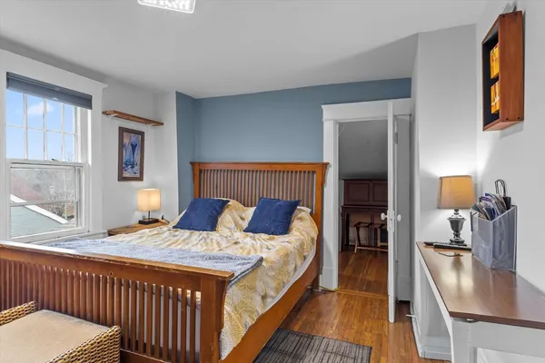 a bedroom with a bed and a flat tv screen on a dresser