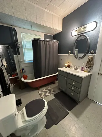 a bathroom with a sink toilet and mirror