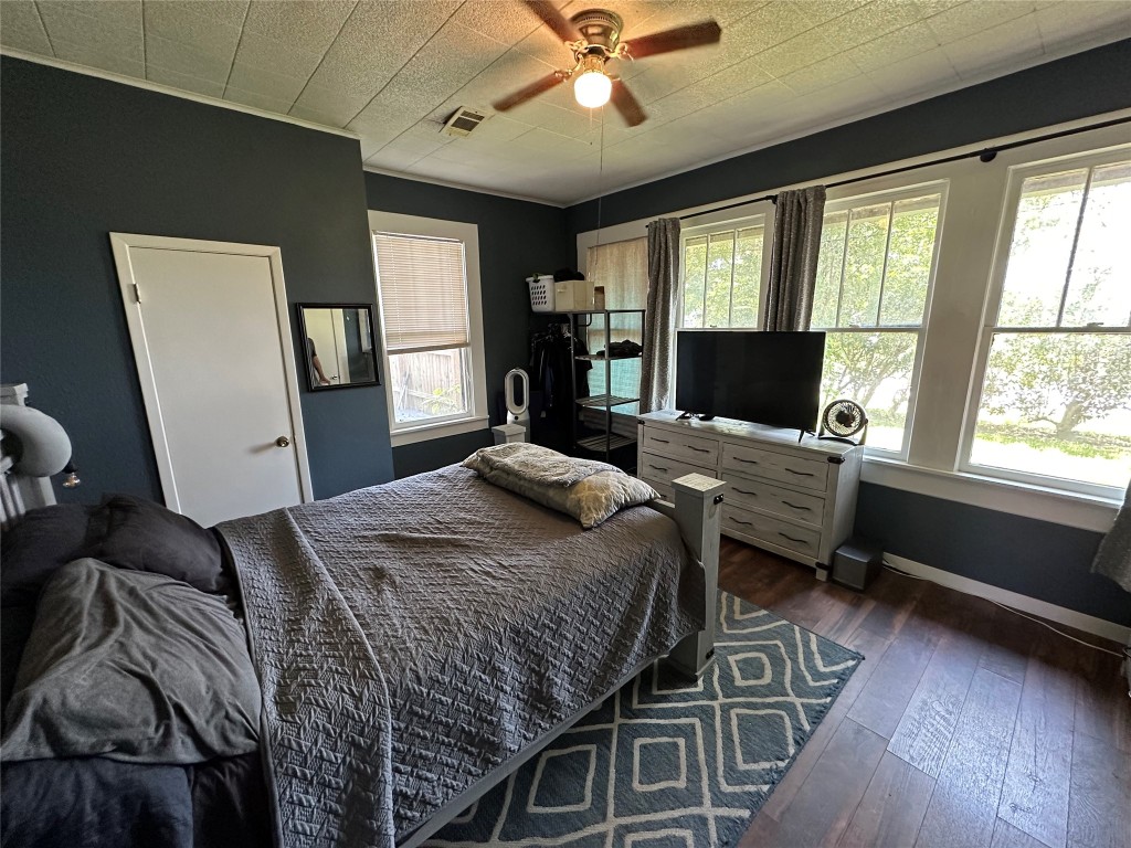 620 North 5th Street Silsbee, TX 77656 - Photo 16 of 33 a bedroom with a bed and wooden floor