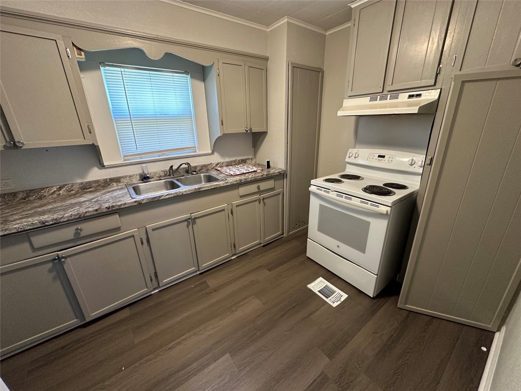 620 North 5th Street Silsbee, TX 77656 - Photo 21 of 33 a kitchen with a stove wooden floor and a sink