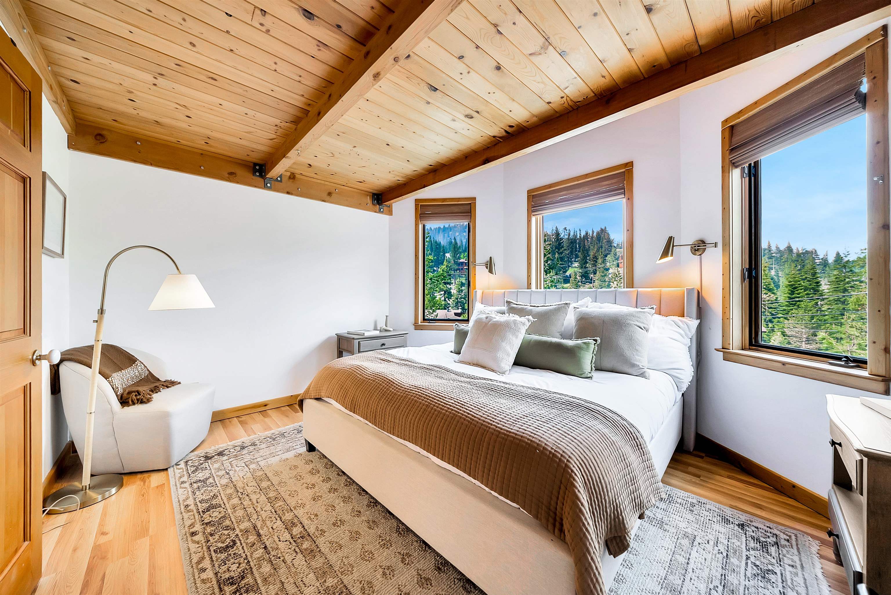 1191 Snow Crest Road Alpine Meadows, CA 96146 - Photo 16 of 28 a bedroom with a bed lamp and a large window