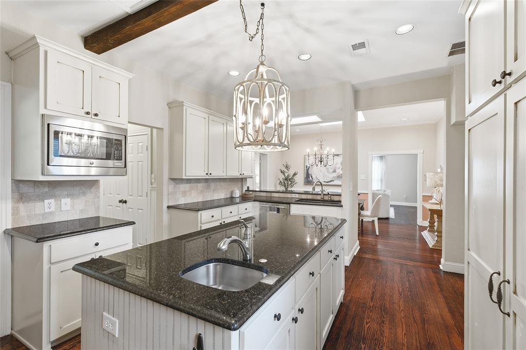 9121 6th Street Frisco, TX 75033 - Photo 5 of 27 a kitchen with stainless steel appliances granite countertop a sink dishwasher and cabinets with wooden floor
