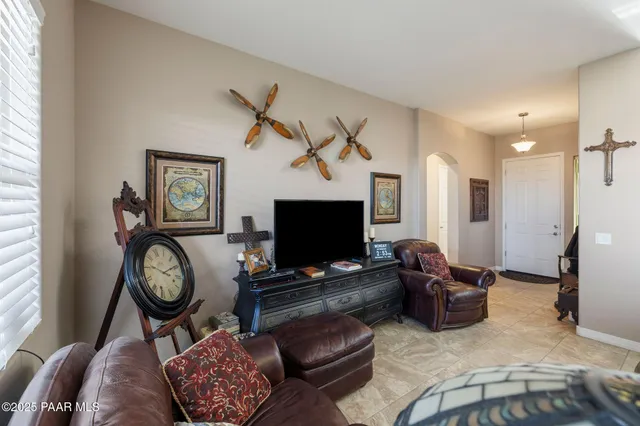 a living room with furniture ceiling fan and a window