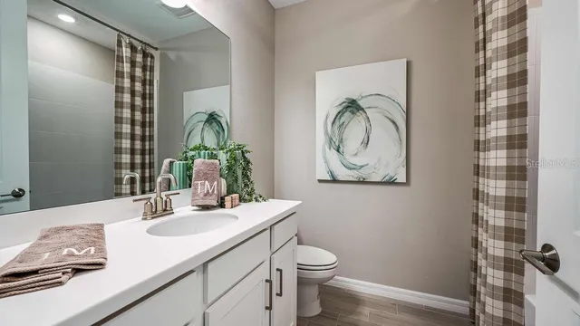 an aerial view of a house with a garden and lake view