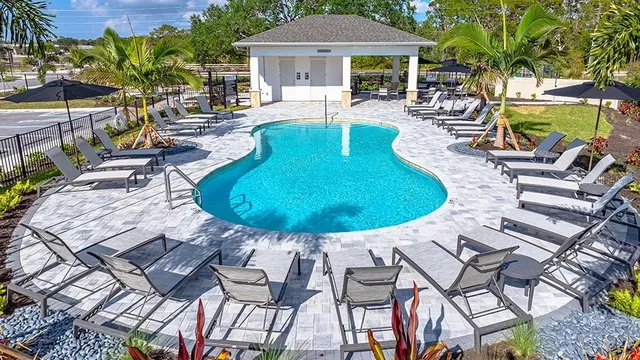 a view of house with swimming pool outdoor seating