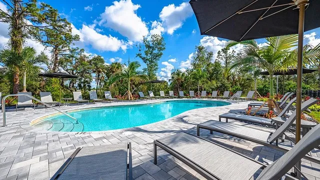 a view of a house with backyard and sitting area