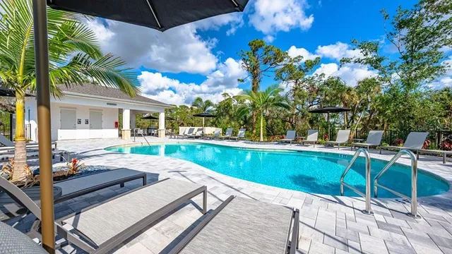 a view of a patio with table and chairs under an umbrella