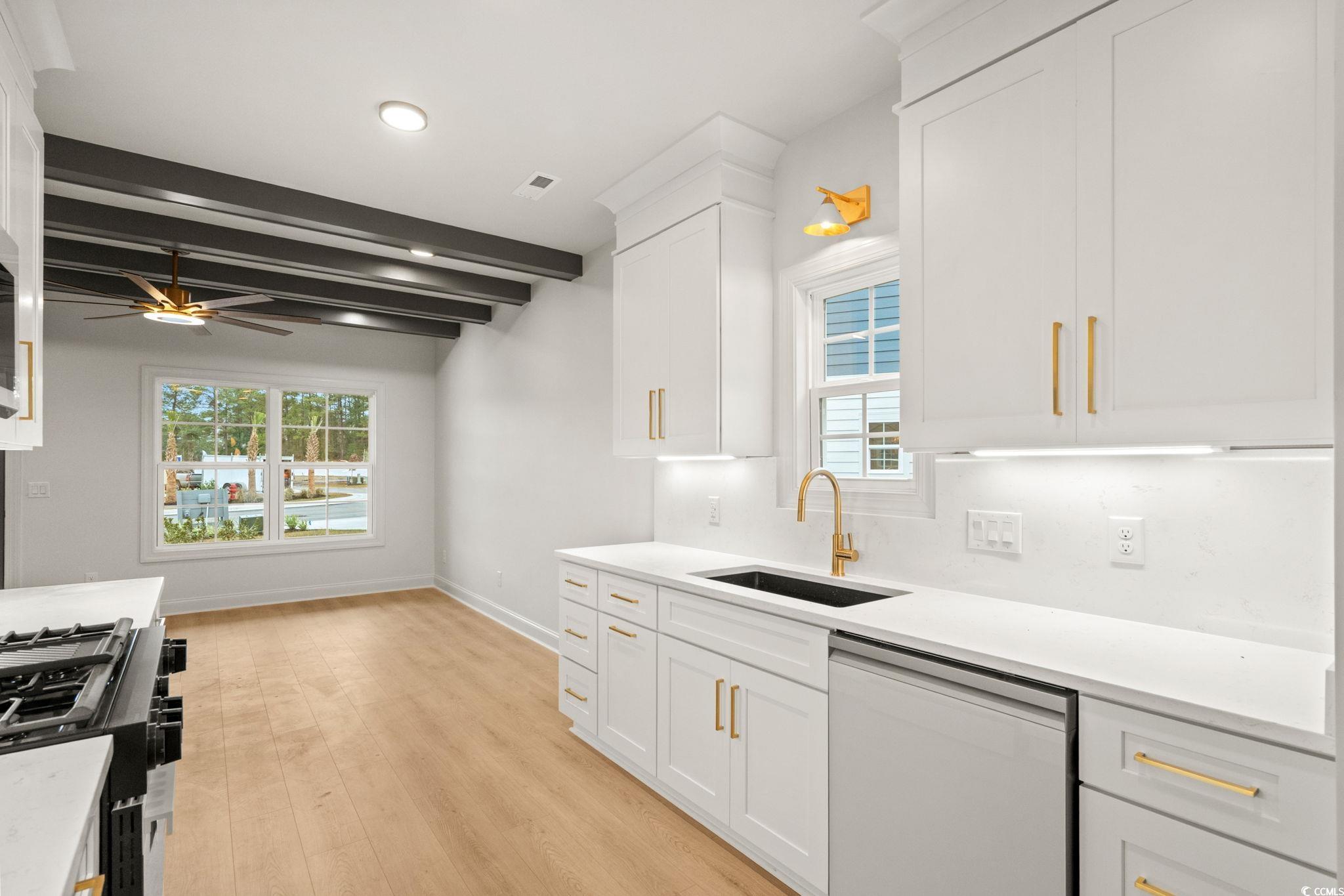 144 Arbor Ridge Circle Conway, SC 29526 - Photo 11 of 40 Kitchen with dishwasher, healthy amount of natural light, white cabinetry, beamed ceiling, and light stone counters