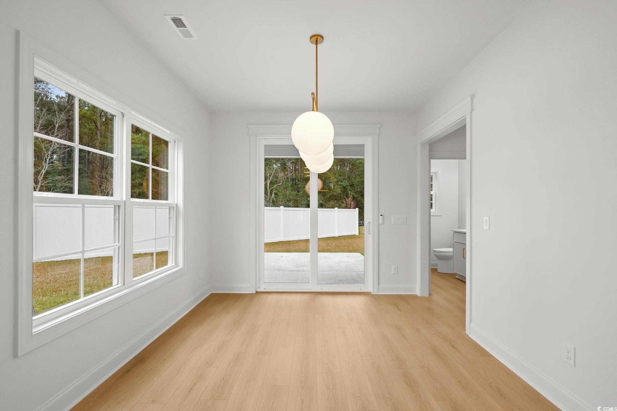 144 Arbor Ridge Circle Conway, SC 29526 - Photo 13 of 40 Unfurnished dining area with light wood-type flooring and baseboards