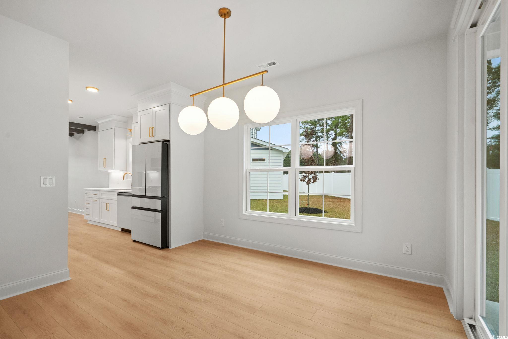 144 Arbor Ridge Circle Conway, SC 29526 - Photo 15 of 40 Unfurnished dining area with light wood finished floors and baseboards