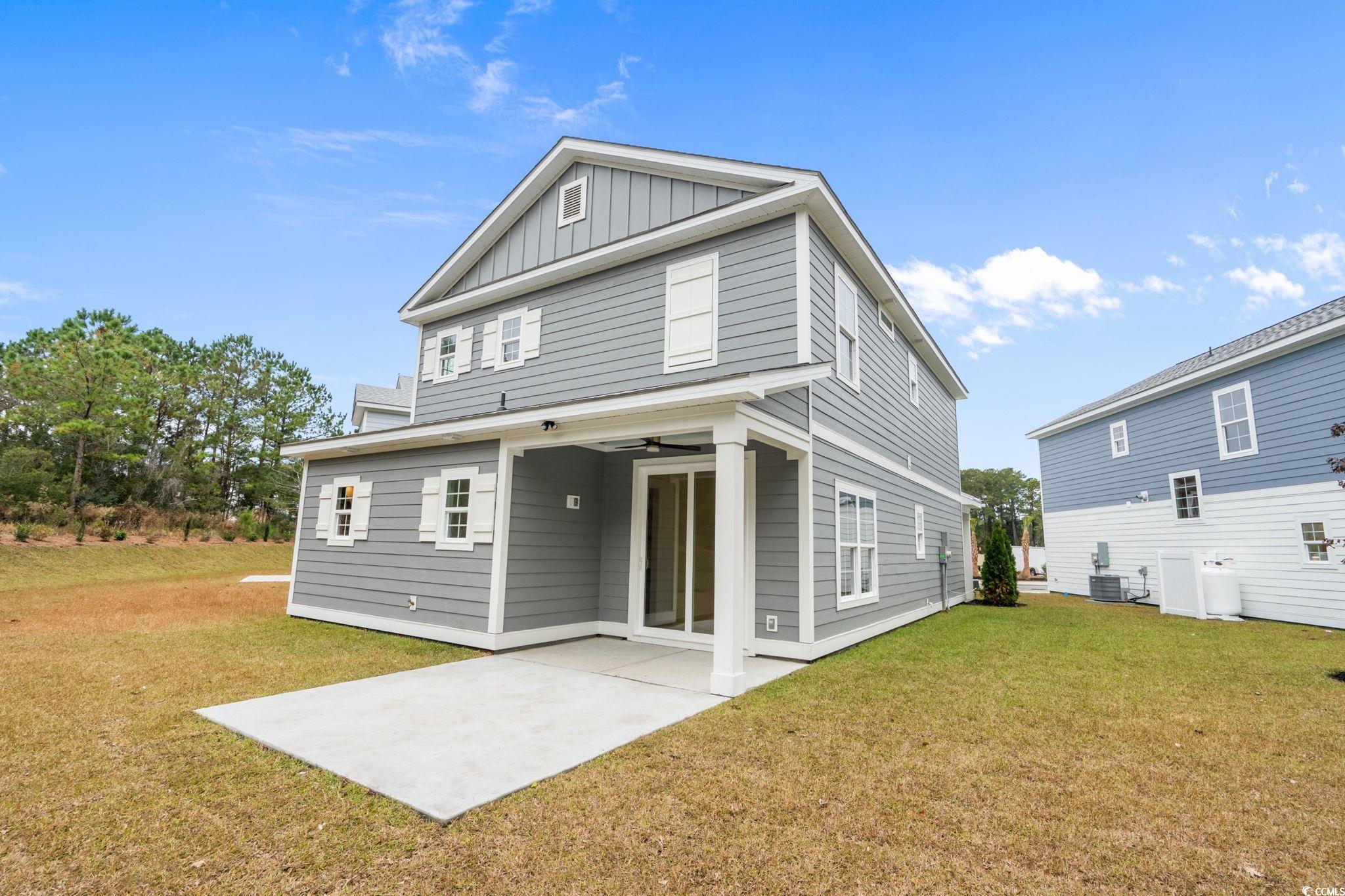 144 Arbor Ridge Circle Conway, SC 29526 - Photo 19 of 40 Rear view of house featuring a patio area, a yard, board and batten siding, and ceiling fan