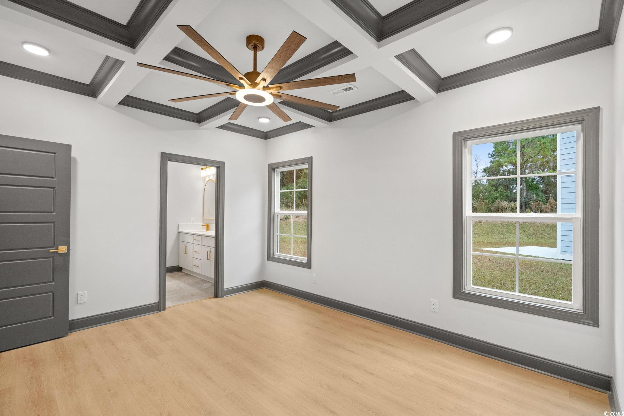 144 Arbor Ridge Circle Conway, SC 29526 - Photo 21 of 40 Unfurnished bedroom with light wood finished floors, a ceiling fan, coffered ceiling, crown molding, and ensuite bathroom