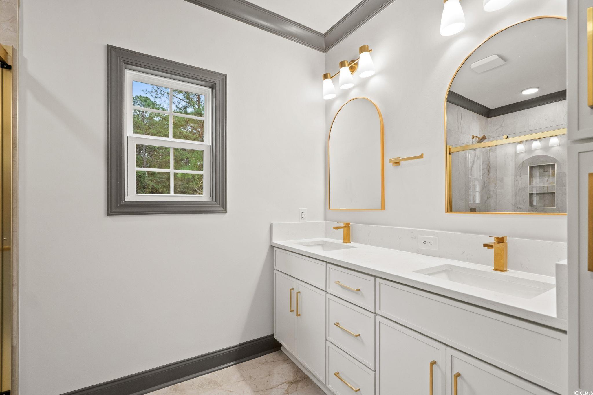 144 Arbor Ridge Circle Conway, SC 29526 - Photo 23 of 40 Bathroom with a marble finish shower, light marble finish floors, double vanity, and ornamental molding