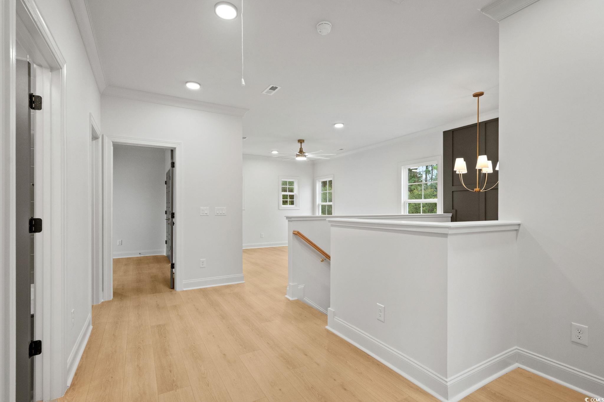 144 Arbor Ridge Circle Conway, SC 29526 - Photo 26 of 40 Corridor featuring an upstairs landing, light wood-type flooring, recessed lighting, ornamental molding, and a chandelier