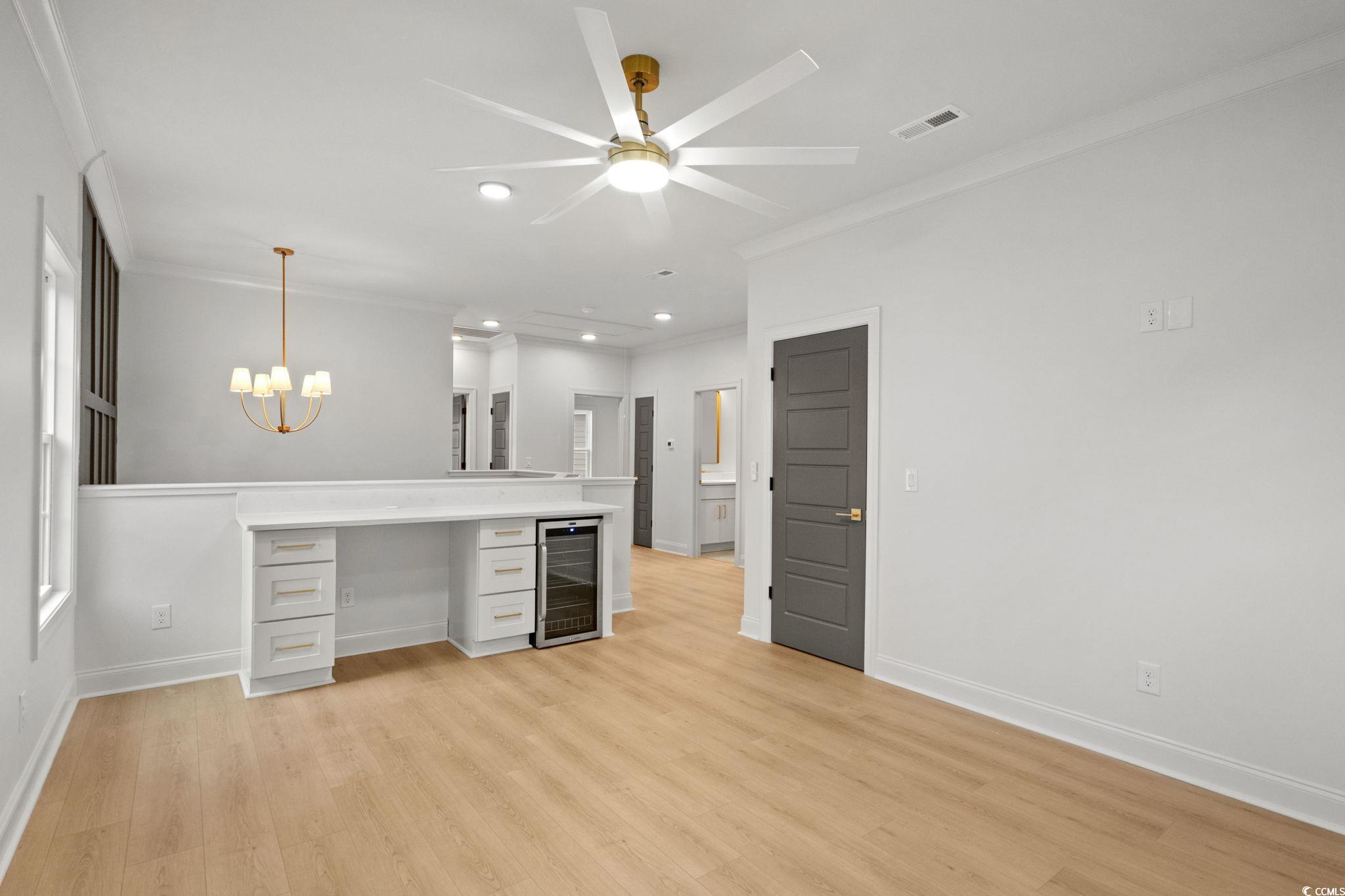 144 Arbor Ridge Circle Conway, SC 29526 - Photo 28 of 40 Kitchen featuring recessed lighting, hanging light fixtures, wine cooler, light wood-style flooring, and ornamental molding