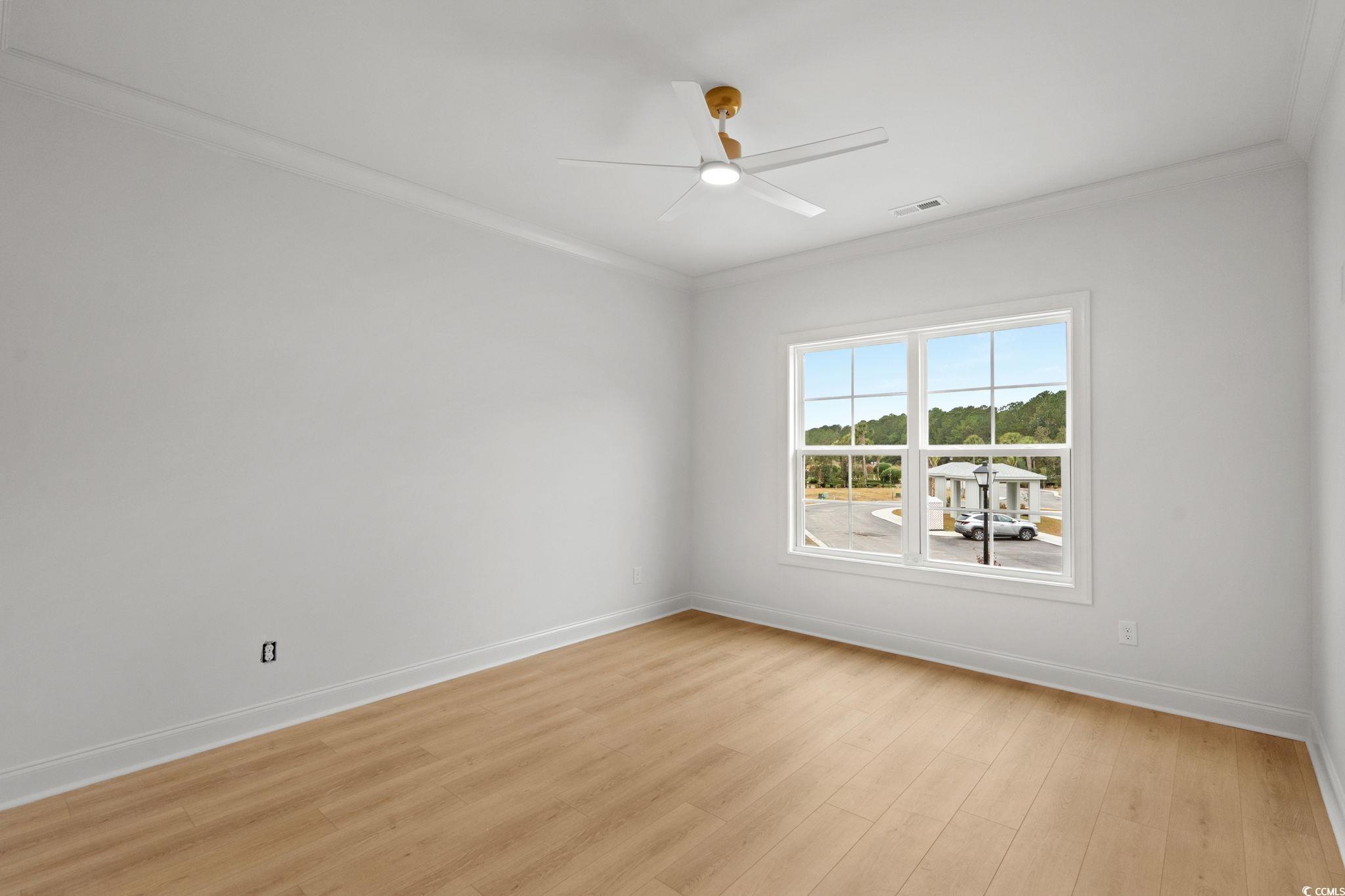 144 Arbor Ridge Circle Conway, SC 29526 - Photo 29 of 40 Spare room with crown molding, light wood-style flooring, and ceiling fan