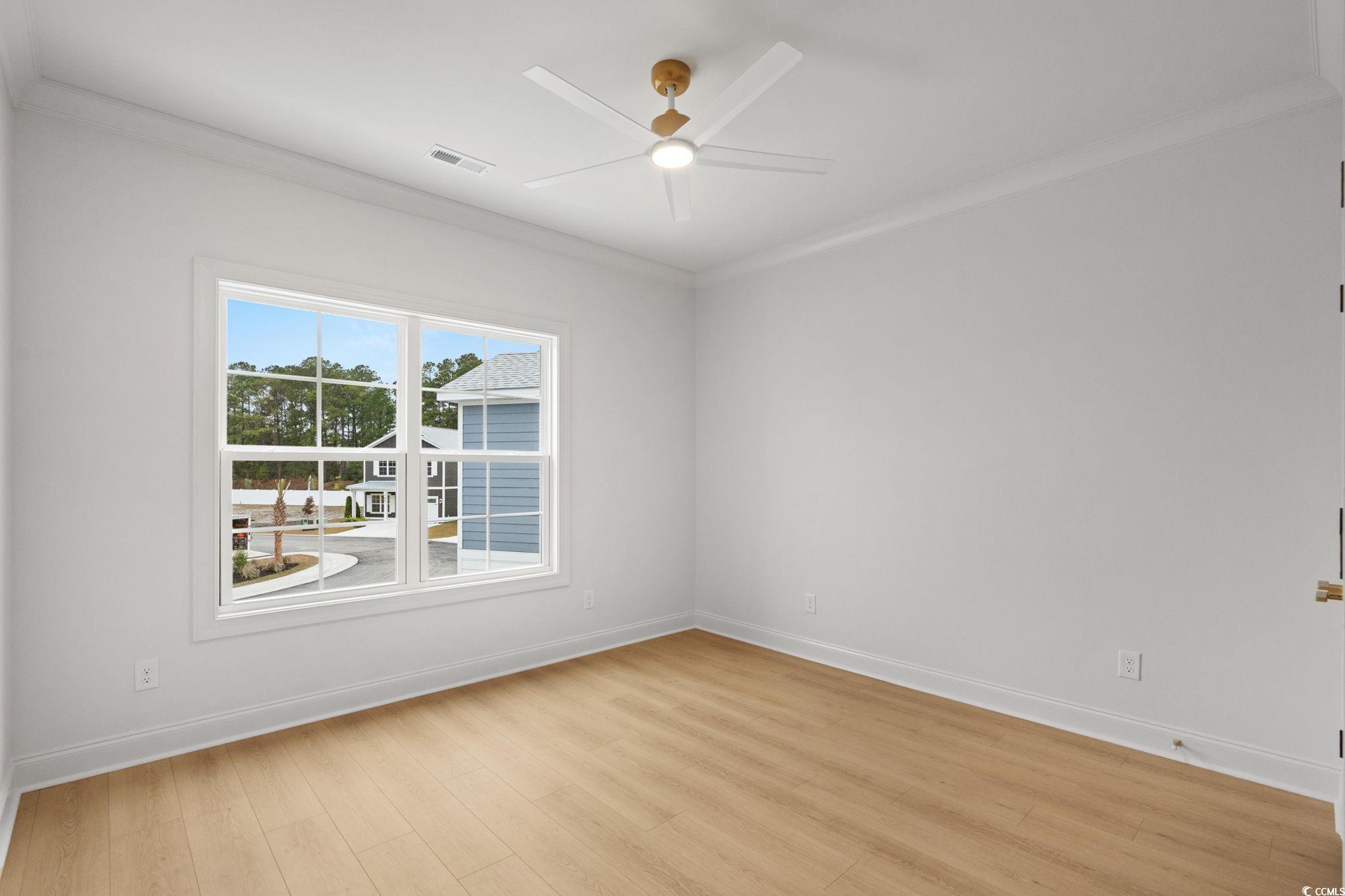 144 Arbor Ridge Circle Conway, SC 29526 - Photo 30 of 40 Unfurnished room featuring crown molding, light wood-style floors, and a ceiling fan