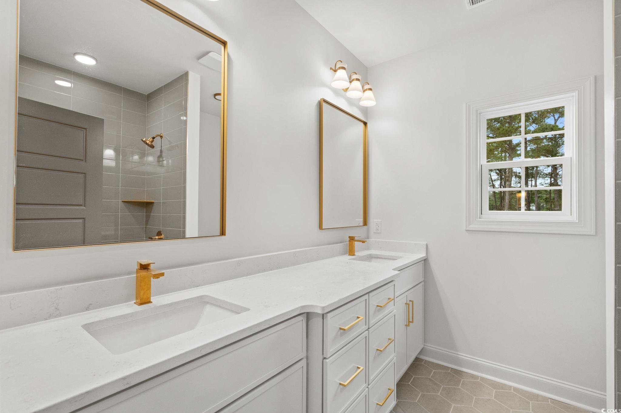 144 Arbor Ridge Circle Conway, SC 29526 - Photo 31 of 40 Full bathroom with double vanity, light tile patterned floors, and tiled shower