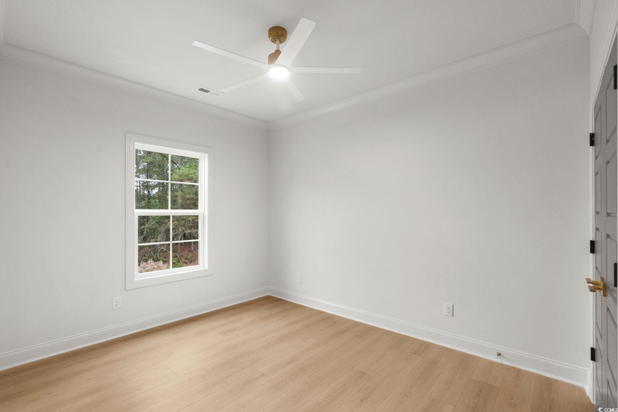 144 Arbor Ridge Circle Conway, SC 29526 - Photo 33 of 40 Empty room with ornamental molding, light wood-style flooring, and a ceiling fan