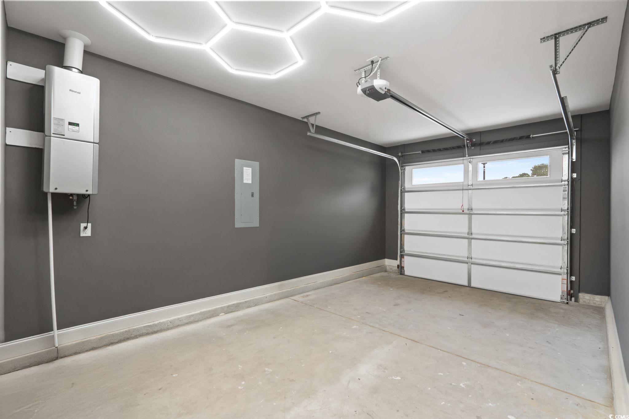 144 Arbor Ridge Circle Conway, SC 29526 - Photo 38 of 40 Garage featuring water heater, a garage door opener, and electric panel