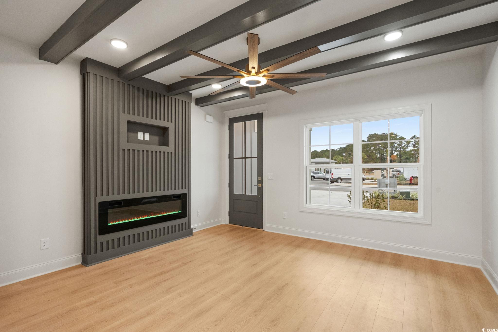 144 Arbor Ridge Circle Conway, SC 29526 - Photo 5 of 40 Unfurnished living room featuring beam ceiling, recessed lighting, light wood finished floors, a ceiling fan, and a glass covered fireplace