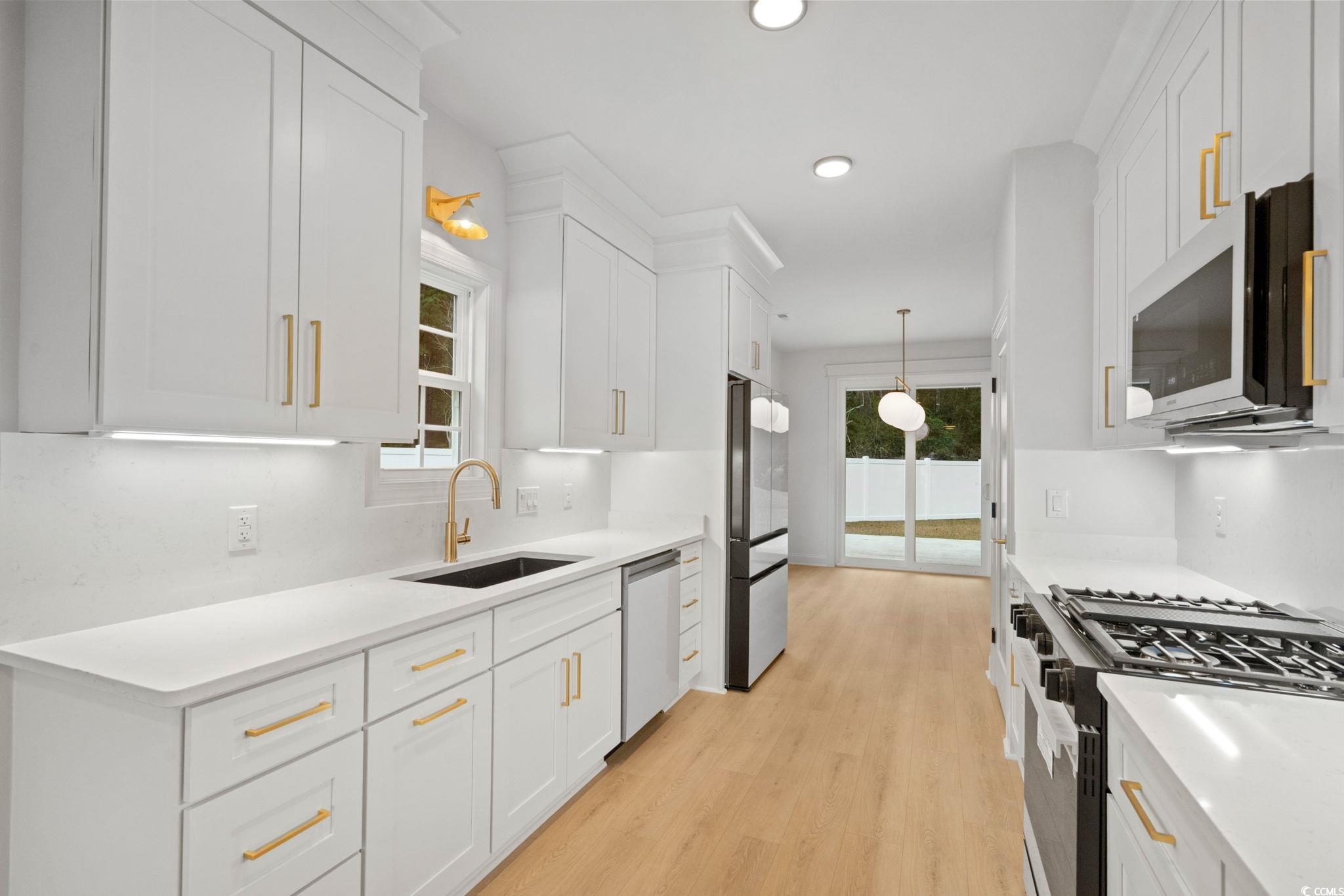 144 Arbor Ridge Circle Conway, SC 29526 - Photo 8 of 40 Kitchen featuring appliances with stainless steel finishes, white cabinets, pendant lighting, and recessed lighting