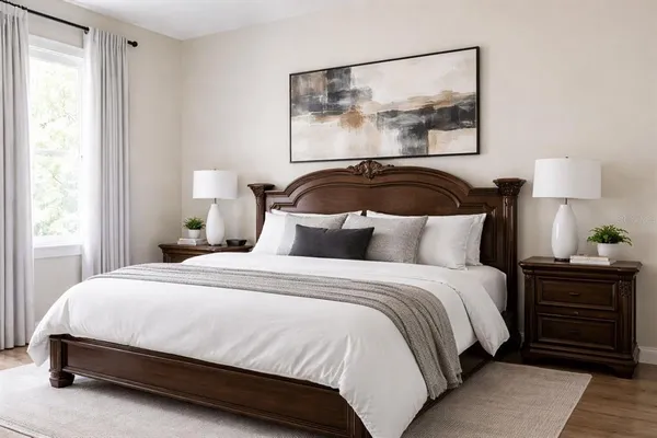 a bedroom with a bed and a painting on the wall
