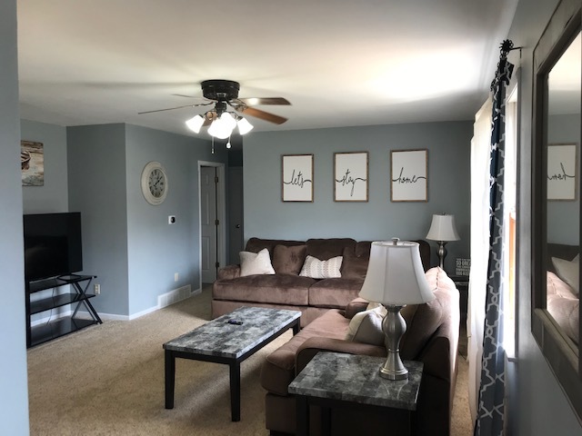 14475 Waller Road Albany, IL 61230 - Photo 6 of 22 a bedroom with furniture and a chandelier