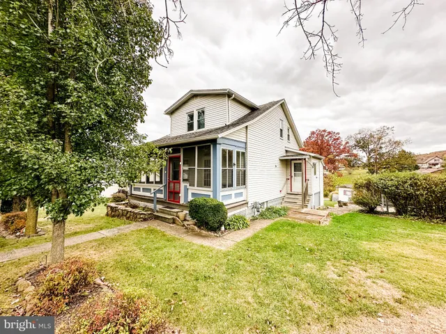a view of a house with a yard porch and sitting area