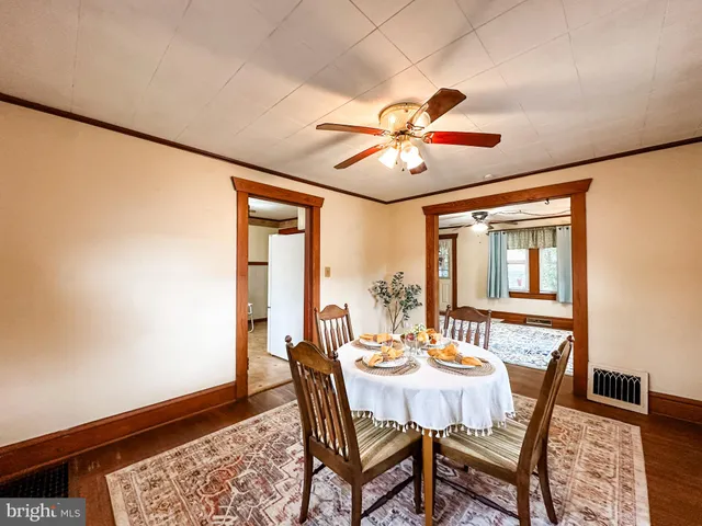 a dining room with furniture a rug and a chandelier