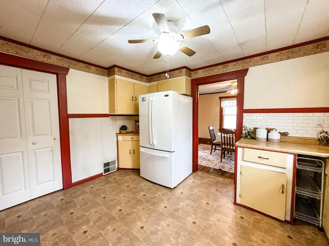 a kitchen with a refrigerator and a stove