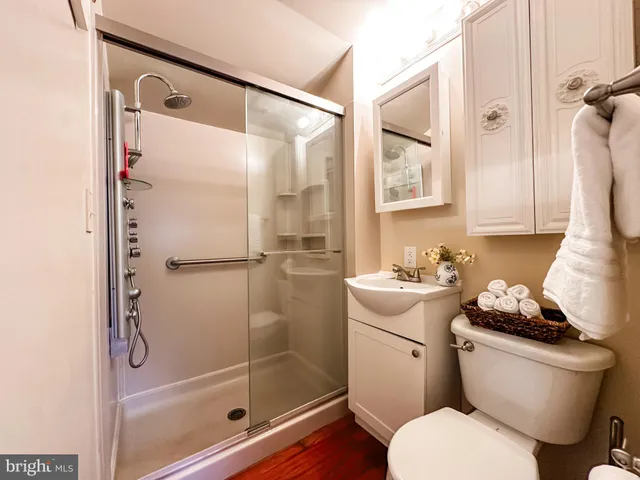 a bathroom with a sink toilet and shower