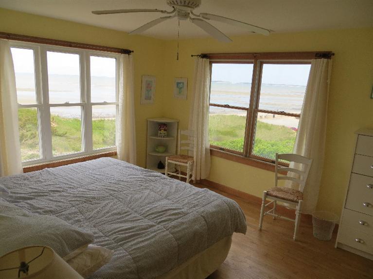230 Salt Works Road Eastham, MA 02642 - Photo 17 of 35 a bedroom with a bed and a table