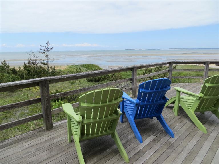 230 Salt Works Road Eastham, MA 02642 - Photo 2 of 35 a view of a chairs and table on the deck