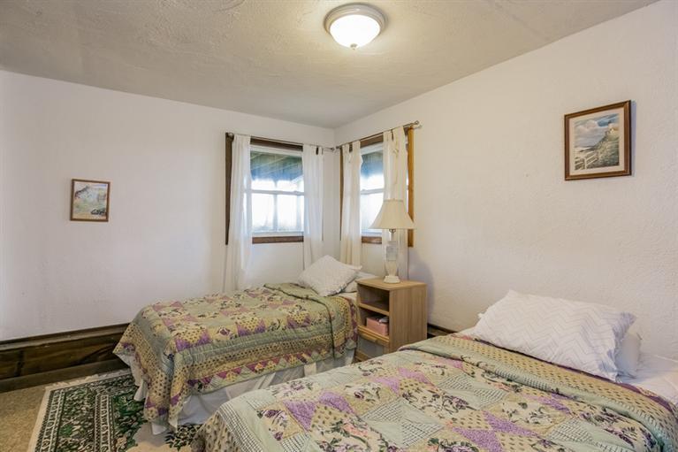 230 Salt Works Road Eastham, MA 02642 - Photo 28 of 35 a bedroom with a bed and wooden floor