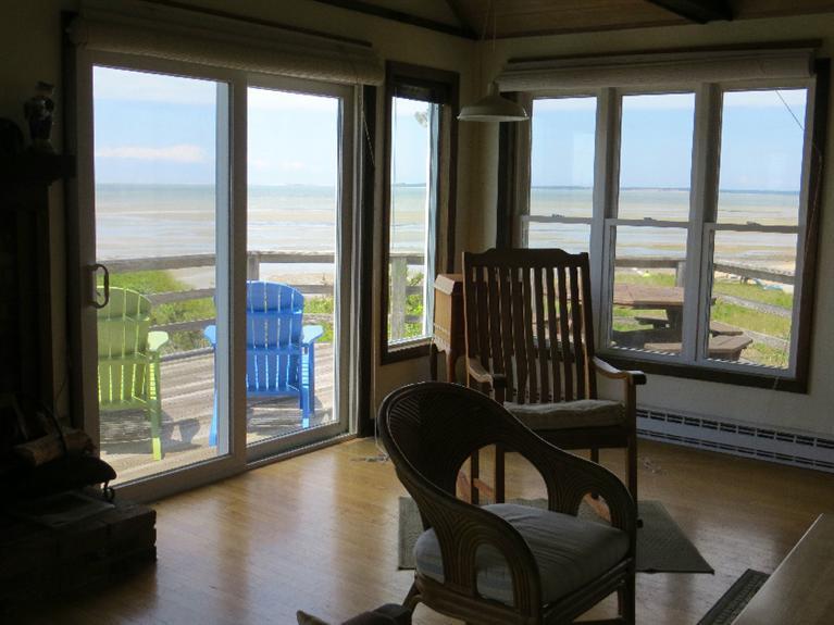 230 Salt Works Road Eastham, MA 02642 - Photo 6 of 35 a living room with furniture and a floor to ceiling window