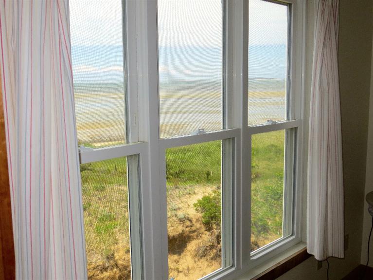 230 Salt Works Road Eastham, MA 02642 - Photo 10 of 35 a view of an empty room with wooden floor and windows