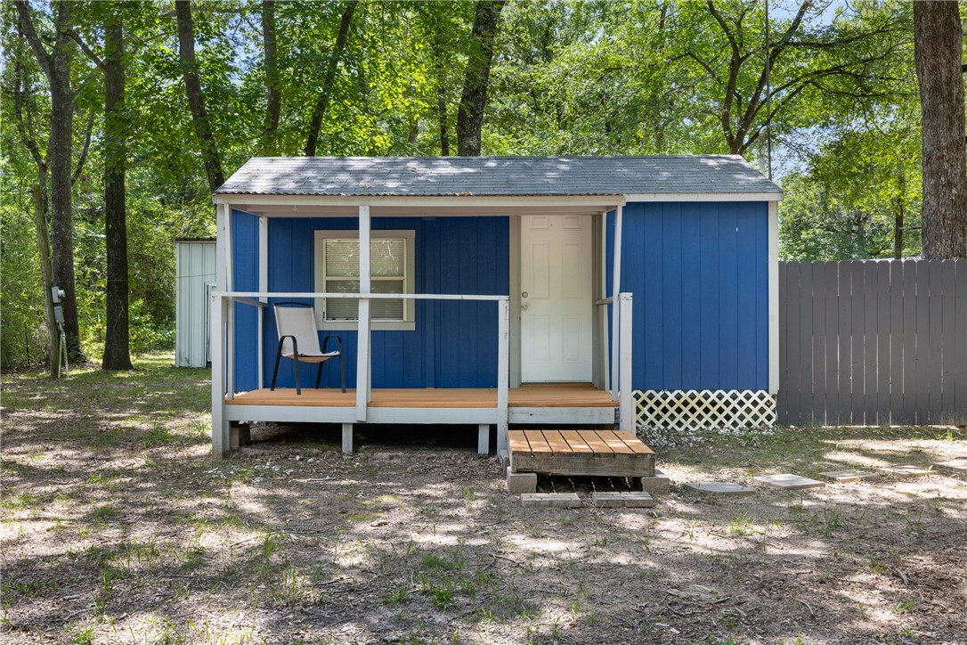 12255 County Road Centerville, TX 75833 - Photo 17 of 26 a wooden bench sitting in front of a house