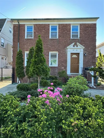 a flower garden in front of a house