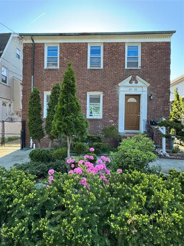 a flower garden in front of a house