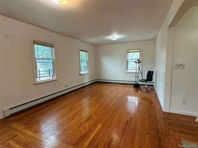a view of a room with wooden floor and window