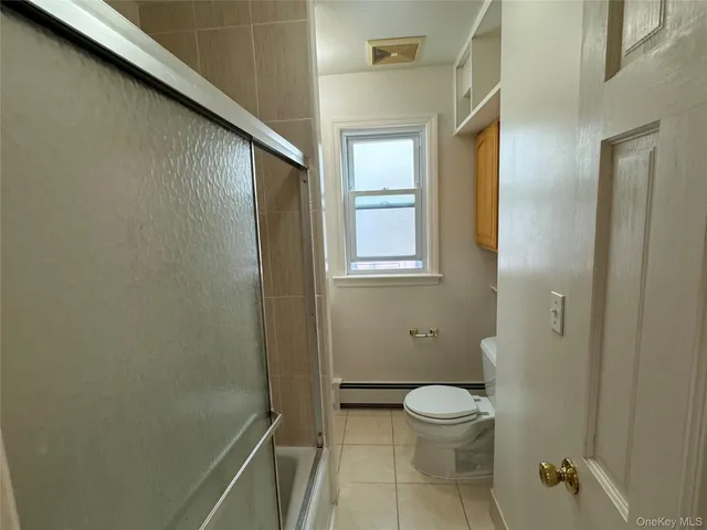 a bathroom with a granite countertop toilet a sink and a mirror