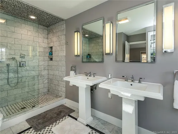 a bathroom with a sink a mirror and a shower