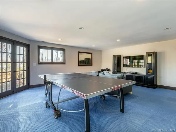 a room with furniture pool table and windows
