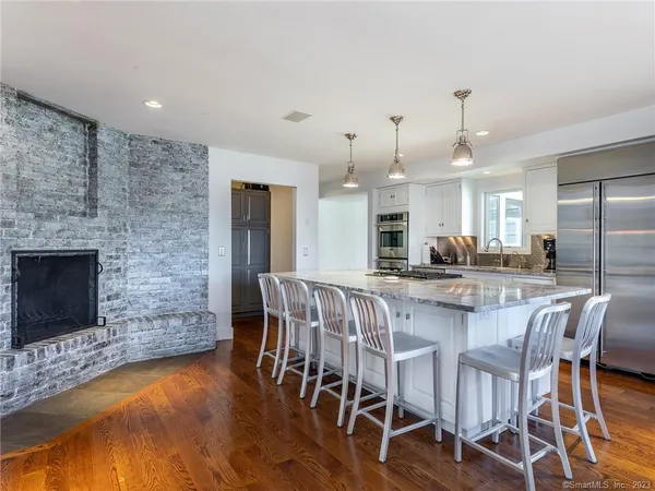 a large kitchen with a table and chairs