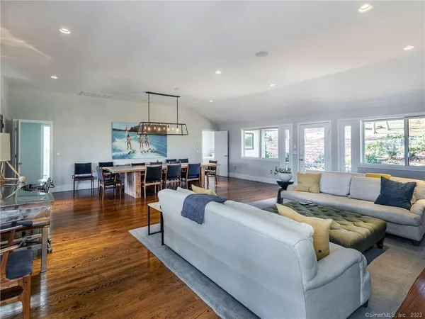 a living room with furniture and a wooden floor