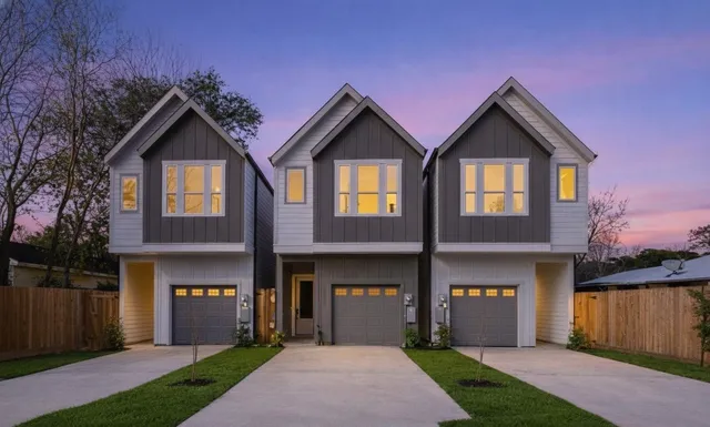 a front view of a house with yard and green space