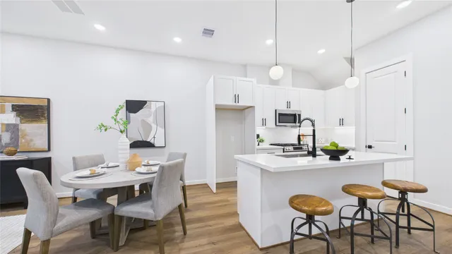 a living room with furniture a chandelier and a dining table with wooden floor